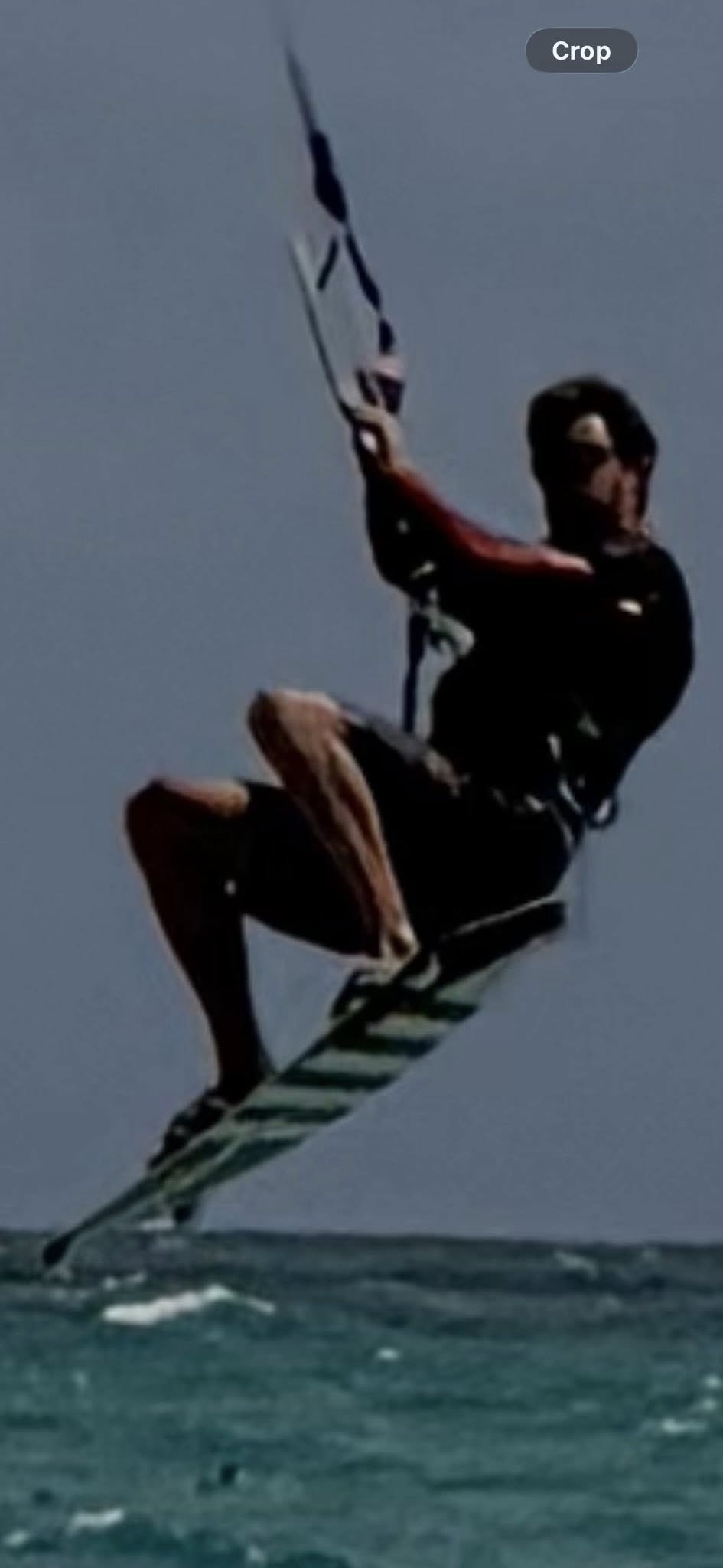 Glen Bradford kiteboarding airborne over the water in Miami