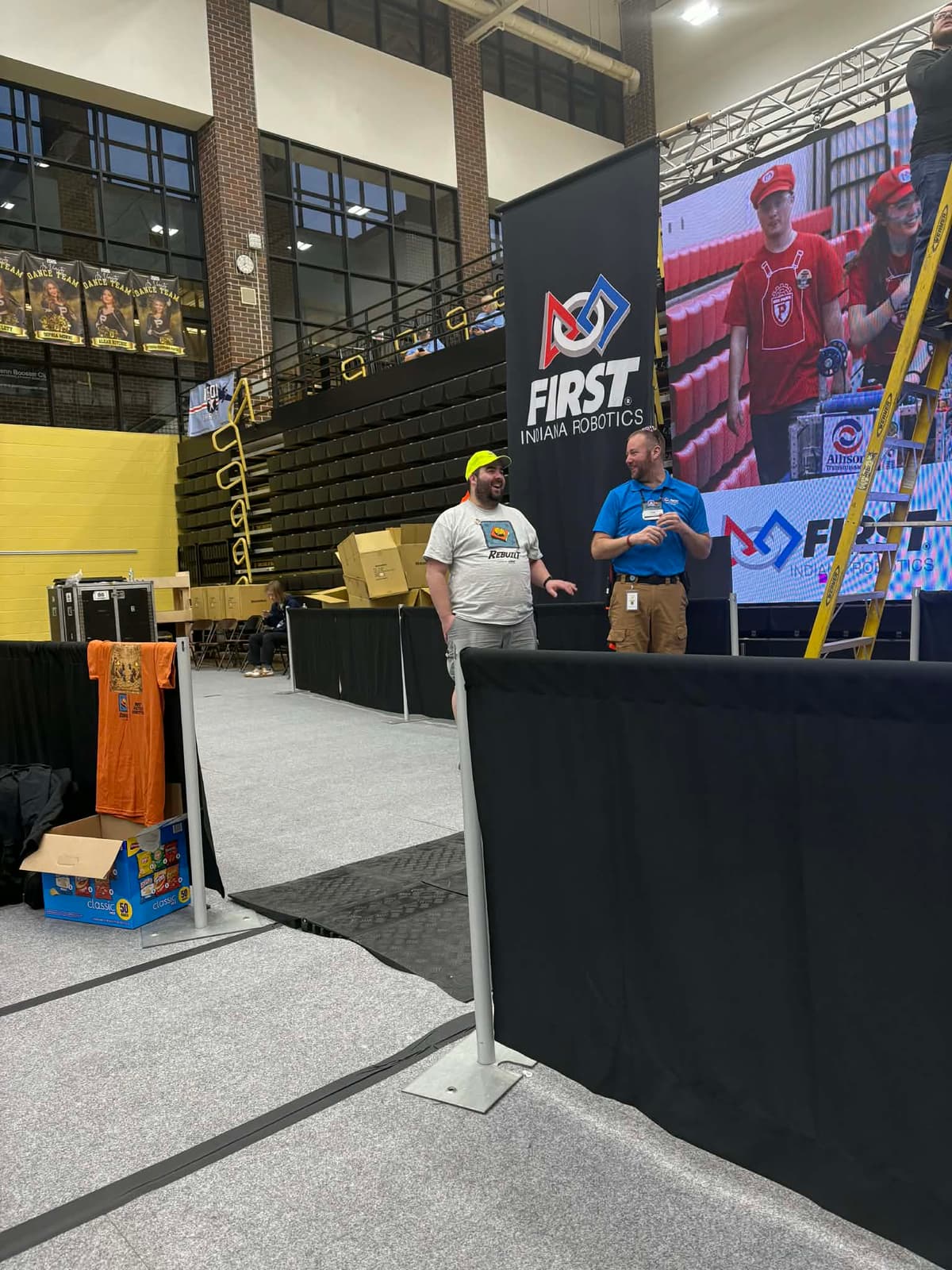 Dan Leathers at the FIRST Indiana Robotics banner during the FIN District Mishawaka Event at Penn High School, March 2026